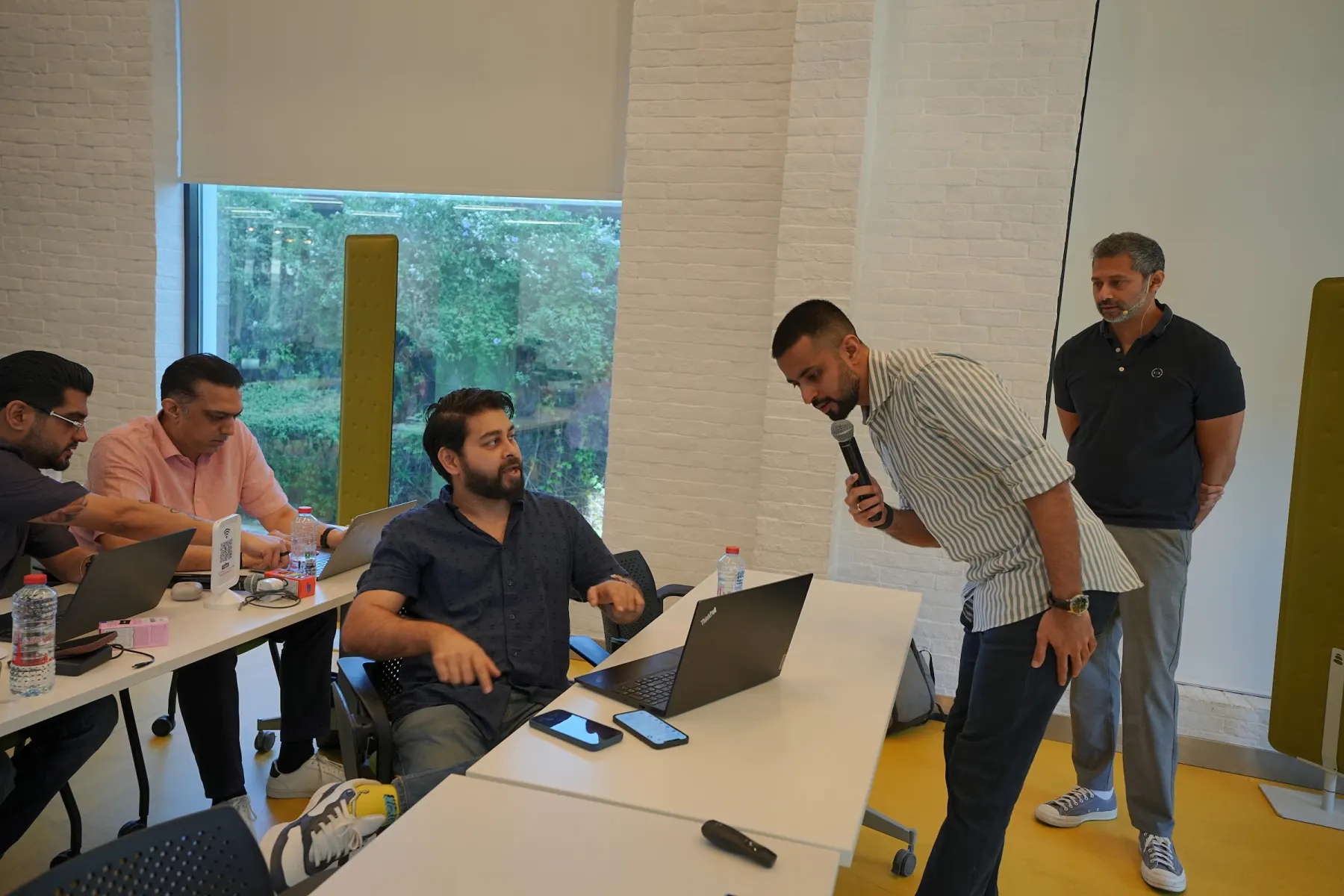 Participants getting help setting up during the Claude Level 2 workshop
