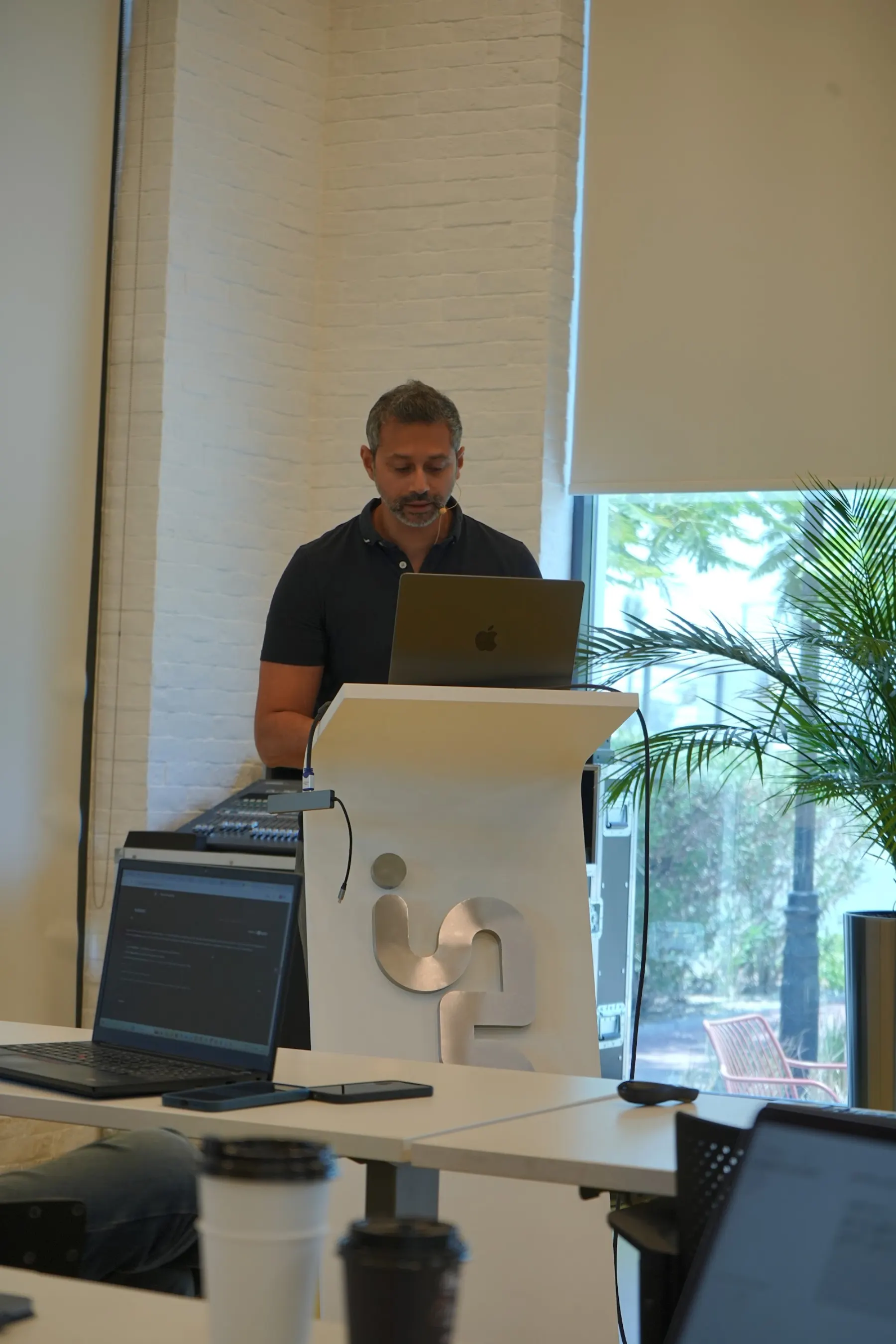 Presenter at the lectern with a laptop