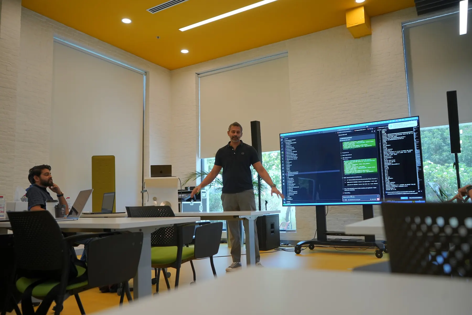 Presenter walking through Claude Code in the terminal on a large screen
