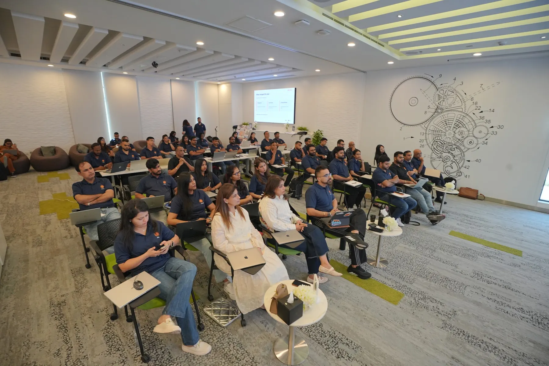 Facilitator addressing a full room of managers during a corporate AI workshop