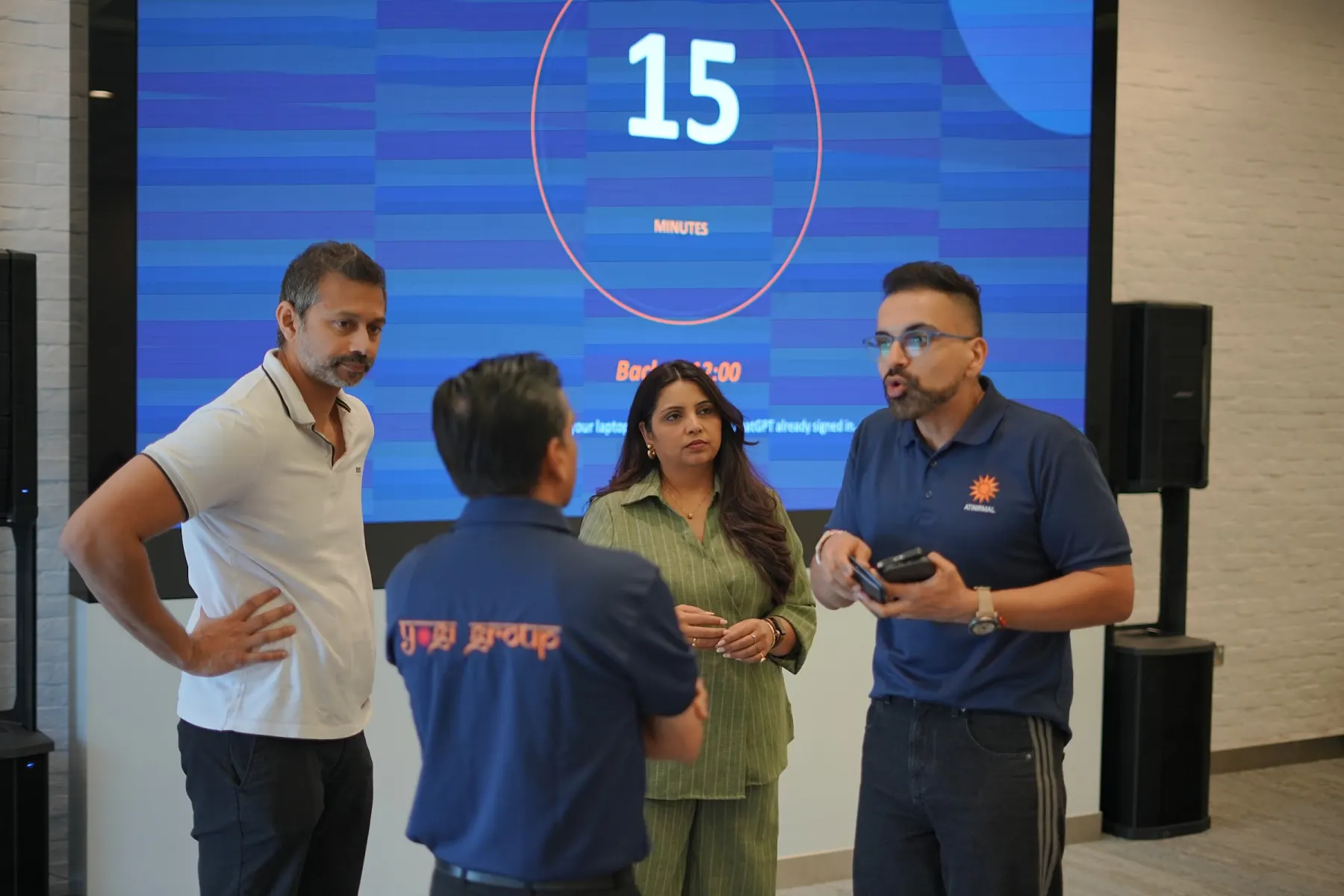 Facilitators huddling with a team during a timed exercise